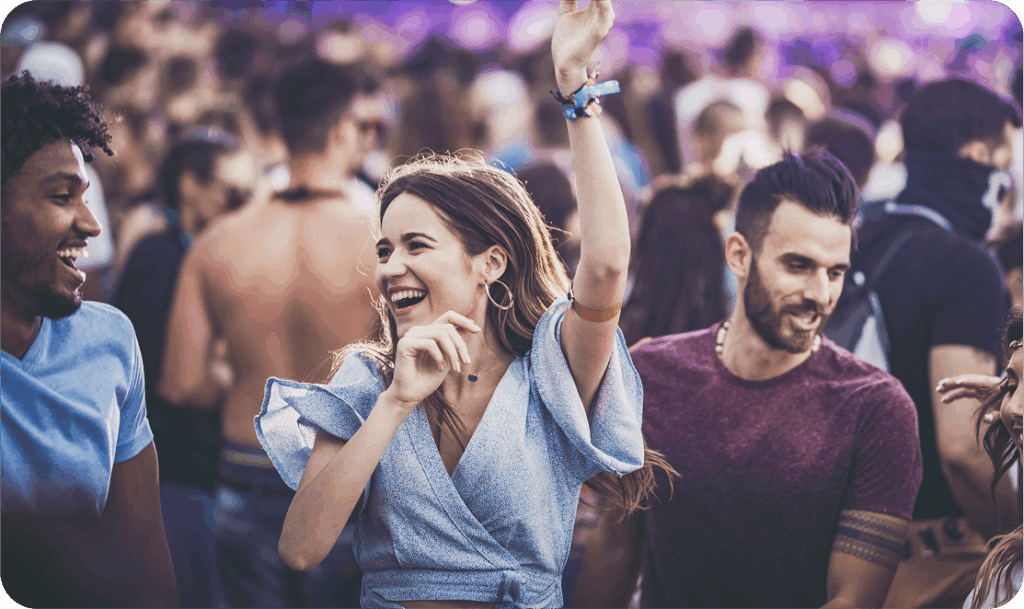 Woman in crowd dancing at a concert