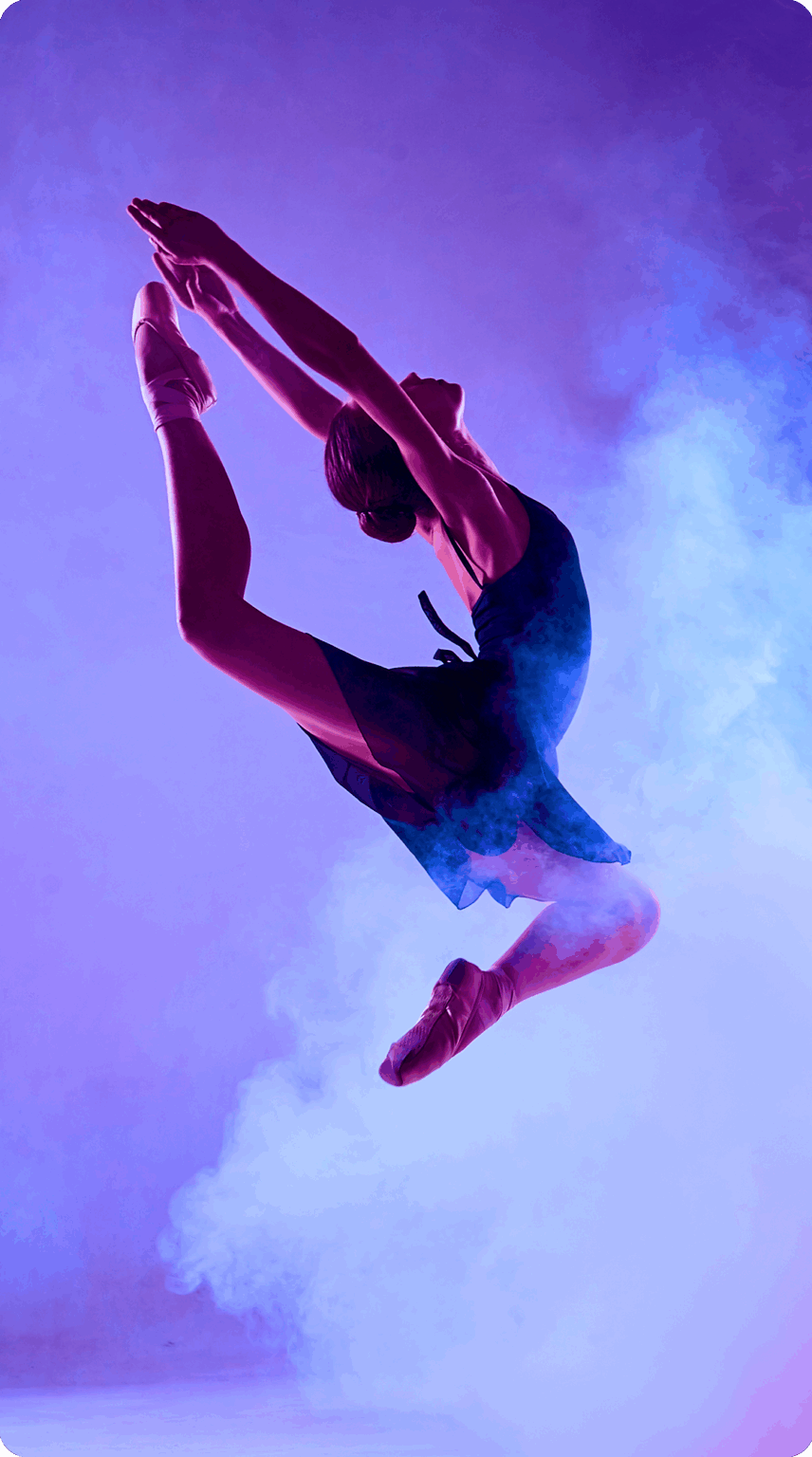 Woman leaping in front of a hazy purple background.