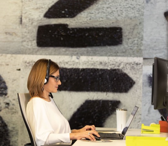 Woman with headset working at a computer