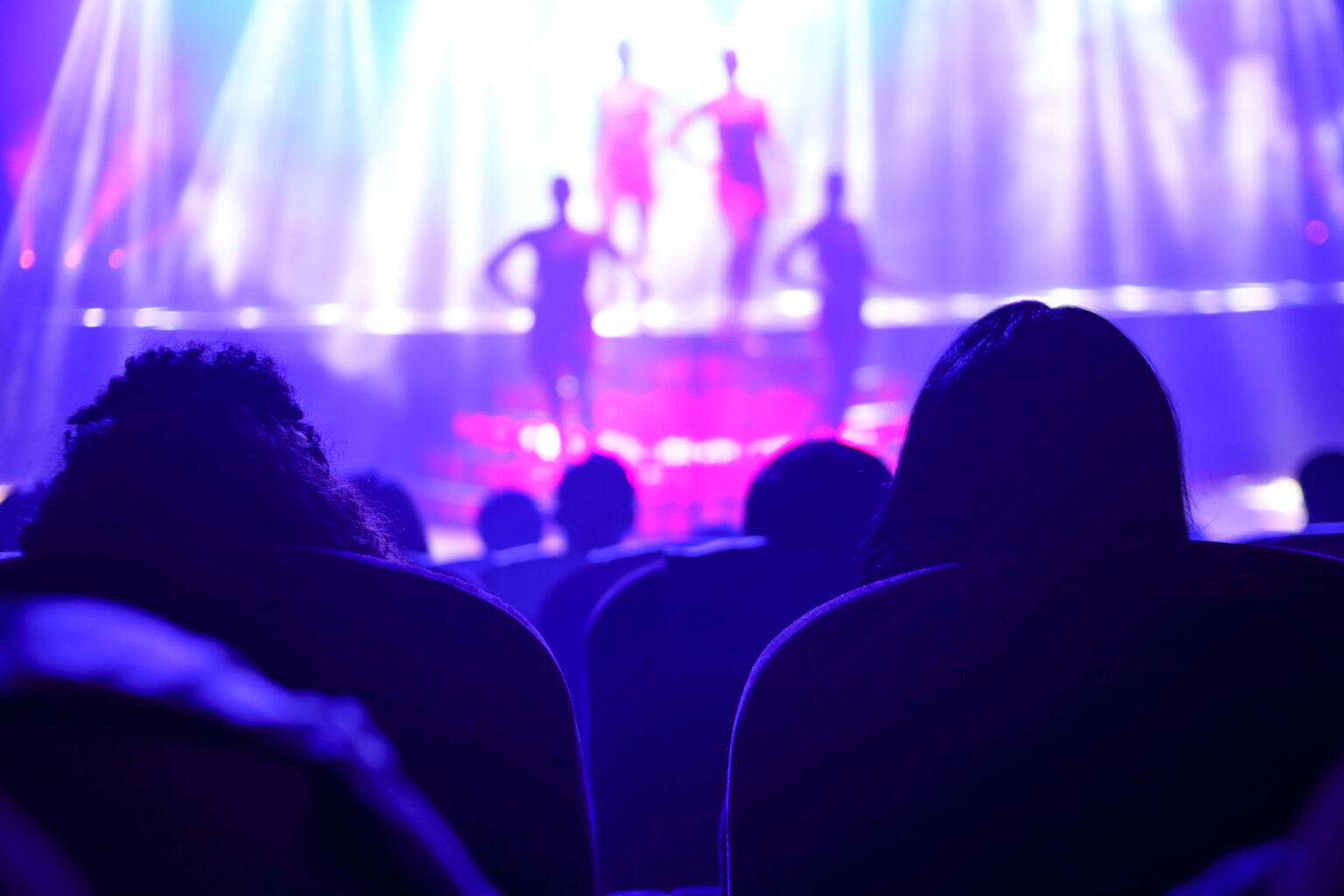audience view of a show in purple lights