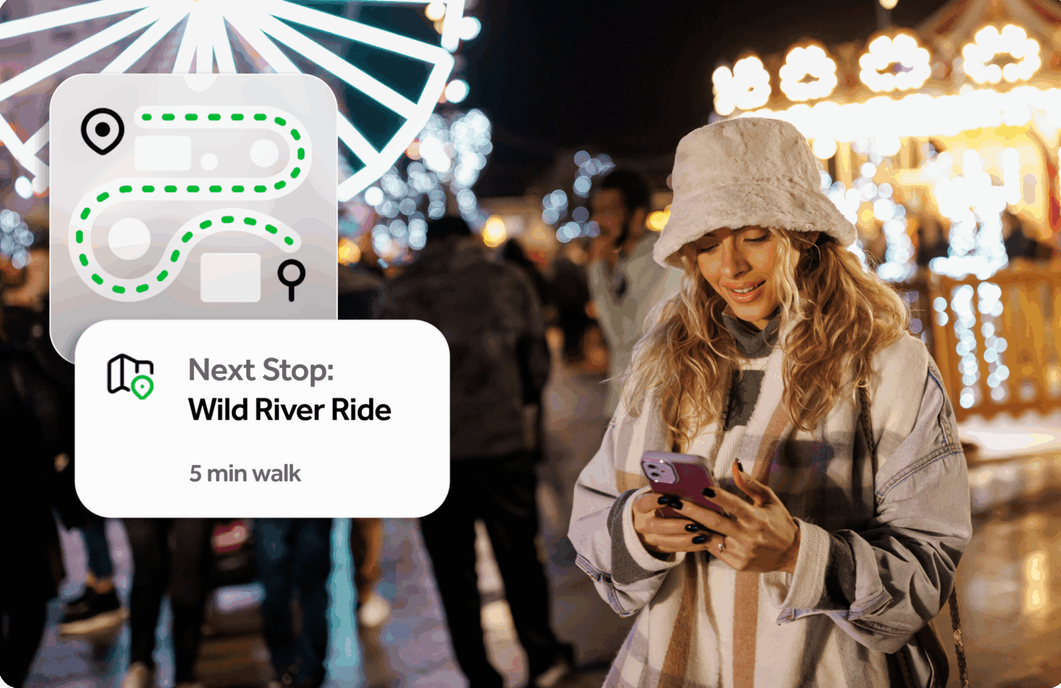 Woman smiling looking at her phone while at a fair at night.