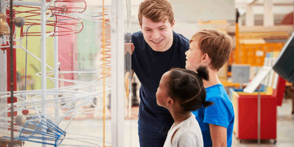 Two children at science center with an adult