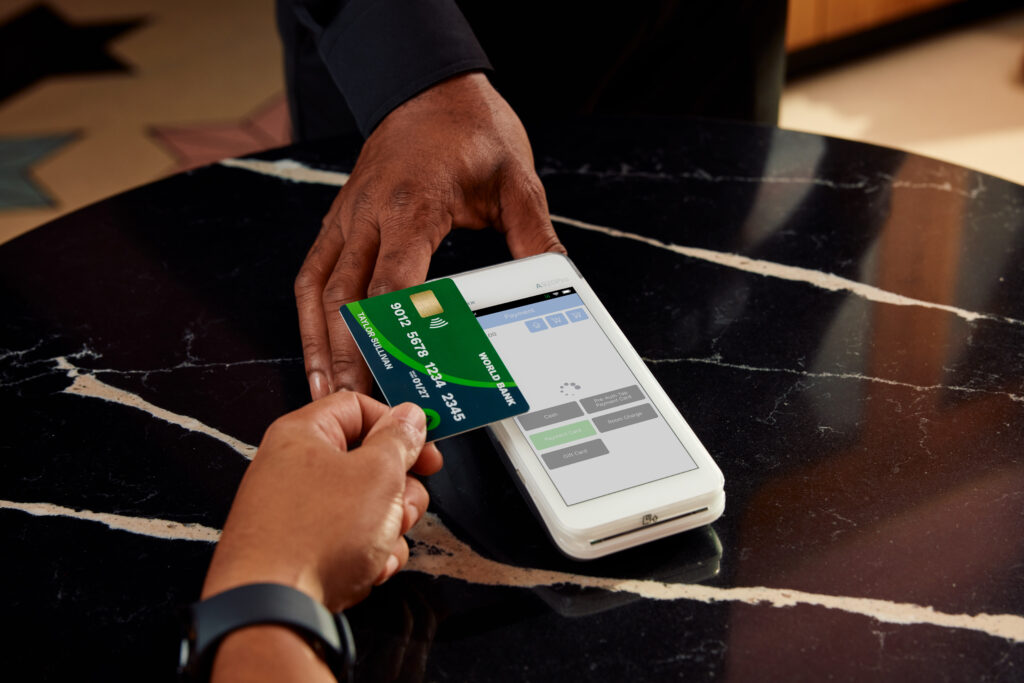 Person tapping their card at checkout