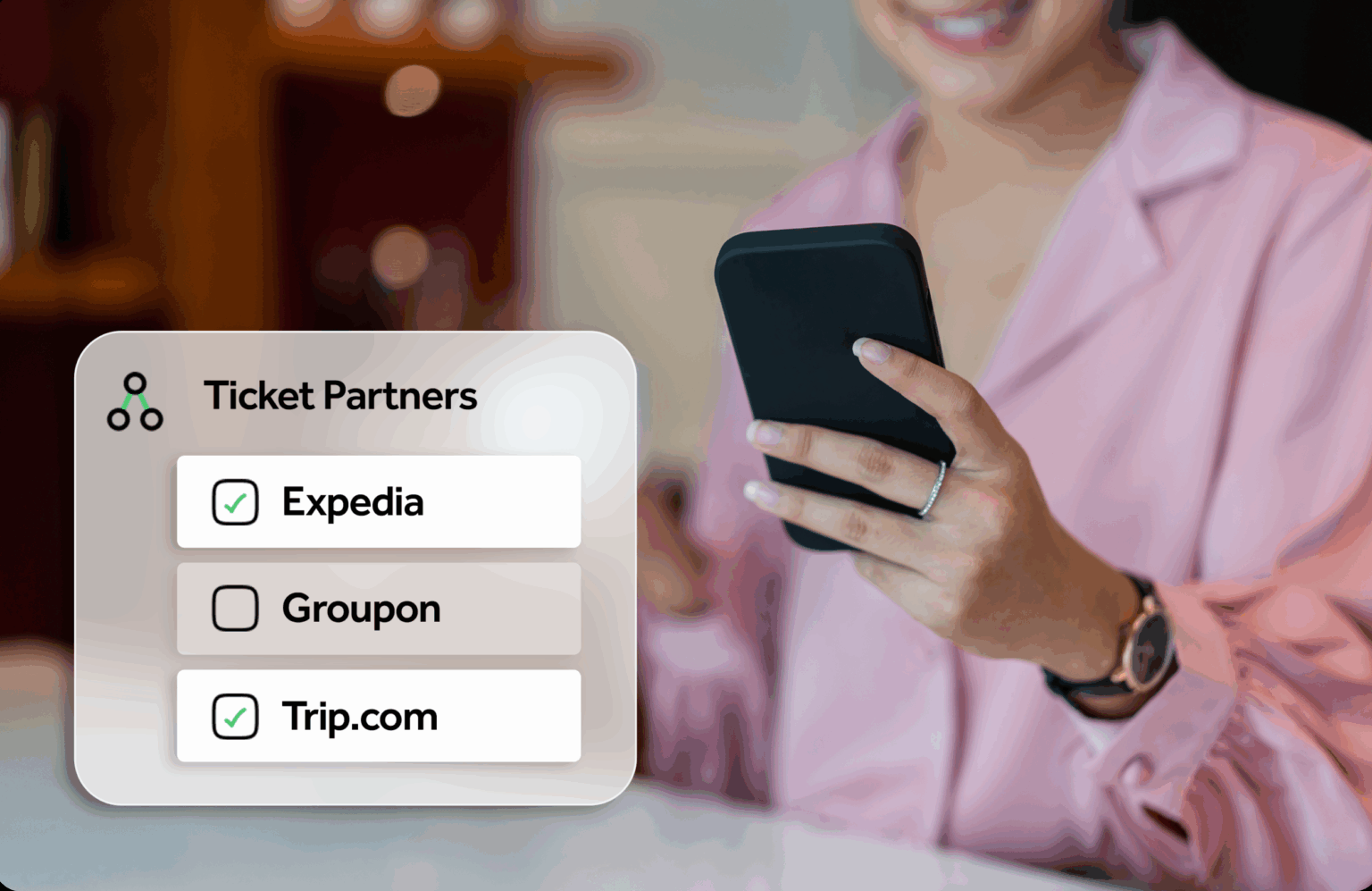 Woman holding a phone and smiling.