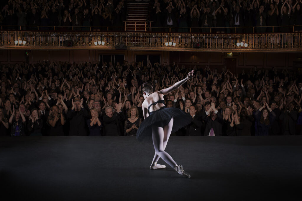 Ballerina bowing on stage in theater