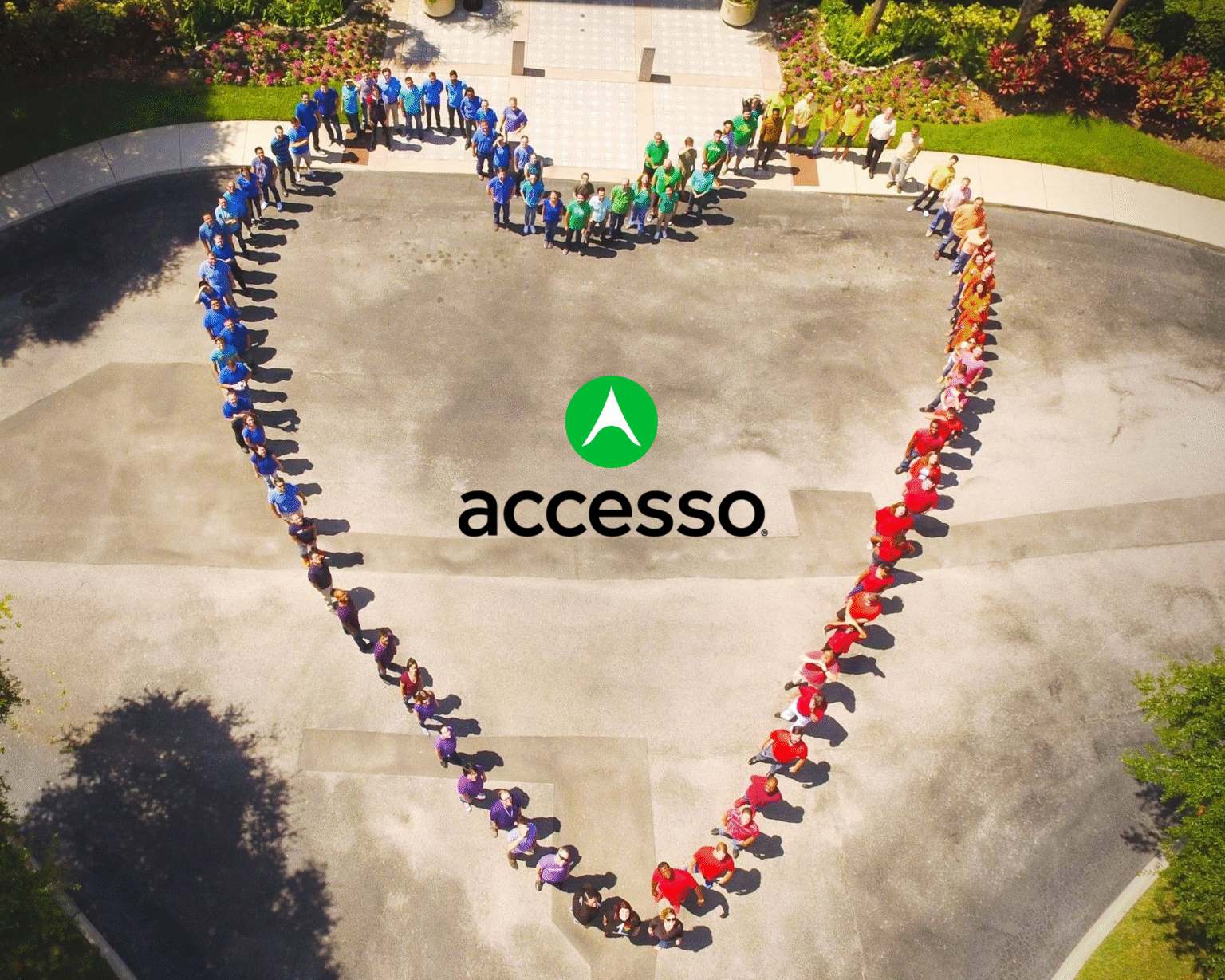 accesso employees standing in the shape of a heart.
